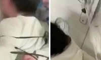 Hình ảnh hai đứa trẻ bị trói tay sau lưng trong video được đưa lên mạng xã hội