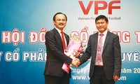 Chủ tịch VPF khóa 3 Trần Anh Tú (phải) nhận hoa chúc mừng từ Chủ tịch VPF khóa 2 Võ Quốc Thắng. Ảnh: VSI.