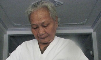 Mẹ Muộn với tấm áo của con ảnh: Trần Tuấn (chụp năm 2011)
