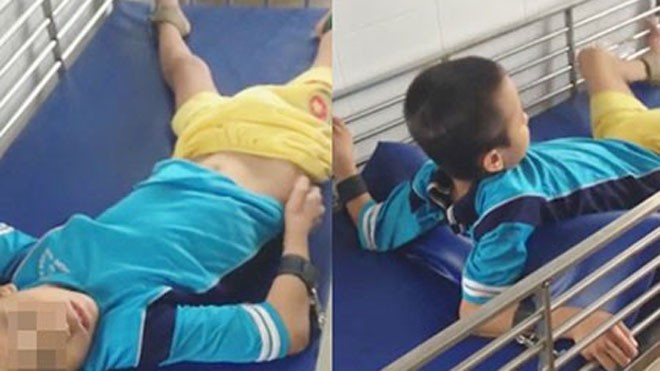 Chăm trẻ bằng cách... cột tứ chi Một bé trai bị cột tứ chi trong cũi. Ảnh: VĂN NGỌC
