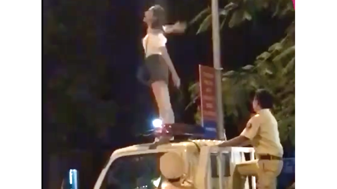 Hiếu kỳ xem cô gái trèo lên nóc xe CSGT nhảy múa la hét Cô gái trèo lên nóc xe lực lượng CSGT nhảy múa (ảnh cắt từ clip)