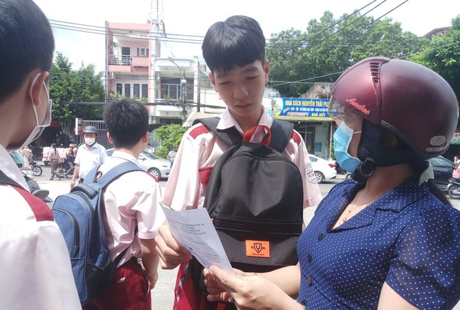 Dịch COVID-19 vào đề thi lớp 10, học sinh hơn hở Giáo viên và thí sinh trao đổi bài thi môn Ngữ văn tại điểm thi trường THCS Nguyễn Trãi, Gò Vấp