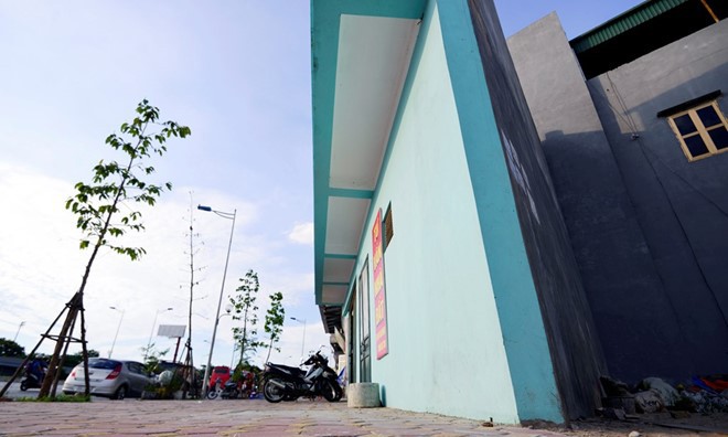 Vì sao nhà siêu mỏng, méo xuất hiện sau mở đường? Ngôi nhà hình tam giác, phía trên được xây đua ra vỉa hè đường vành đai 2 Võ Chí Công. Ảnh: Lê Hiếu.