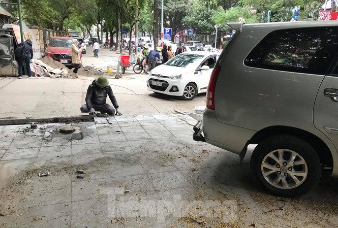 Quận Ba Đình nói gì về việc ô tô đỗ la liệt trên vỉa hè vừa lát đá? Xe ô tô đỗ trên vỉa hè phố Huỳnh Thúc Kháng đang được lát đá. Ảnh: Trường Phong