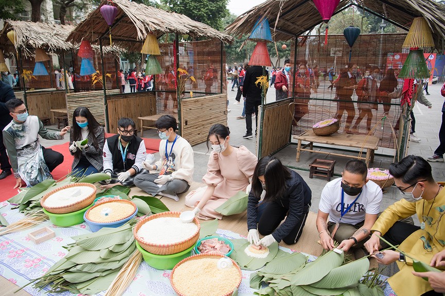 Hoa hậu Đỗ Thị Hà hào hứng gói bánh chưng, được các em học sinh 'bao vây' xin chữ ký - ảnh 4