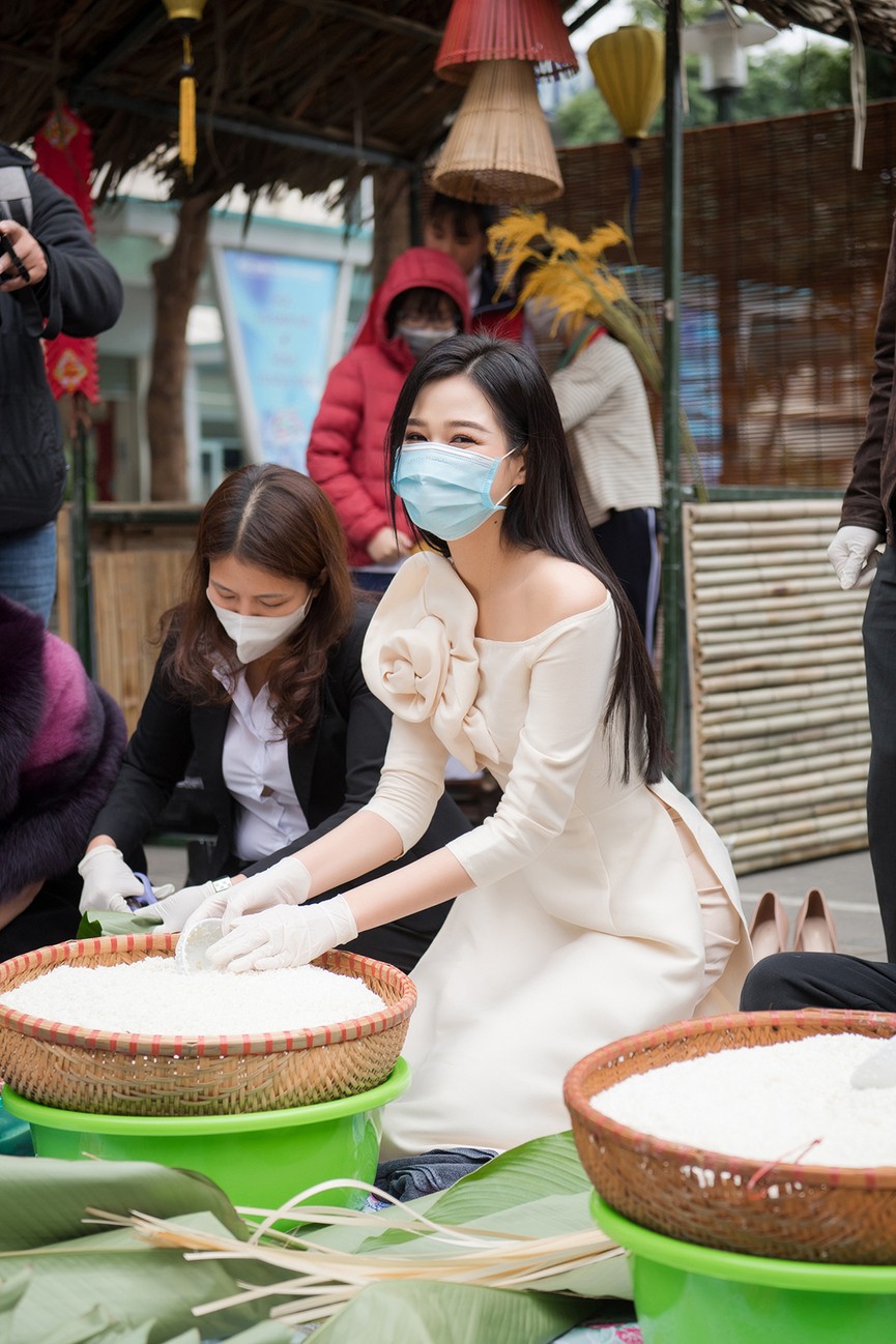 Hoa hậu Đỗ Thị Hà hào hứng gói bánh chưng, được các em học sinh 'bao vây' xin chữ ký - ảnh 5