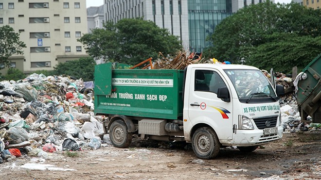 Xe vận chuyển rác mang tên Công ty CP môi trường và dịch vụ đô thị Vĩnh Yên tại bãi rác tự phát Cầu Giấy.