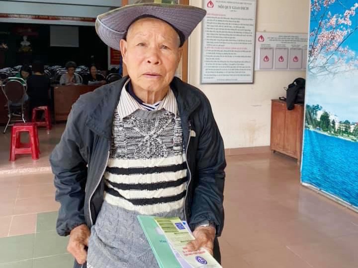 Ông Trần Quang (80 tuổi, Lâm Đồng) cầm trên tay 3 cuốn sổ BHXH tự nguyện vừa tham gia sáng 23/5