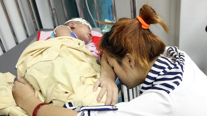 Người mẹ mệt mỏi trông con bị bệnh sởi tại Bệnh viện Nhi Trưng ương, Hà Nội. Ảnh: Ngọc Châu