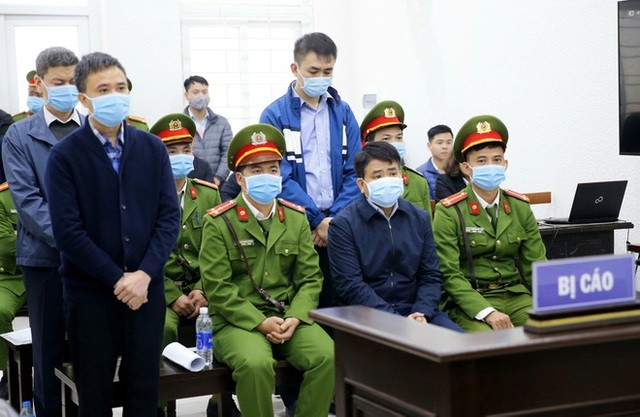 Bị cáo Nguyễn Đức Chung (ngồi) và 3 đồng phạm tại phiên xét xử. (Ảnh: TTXVN).