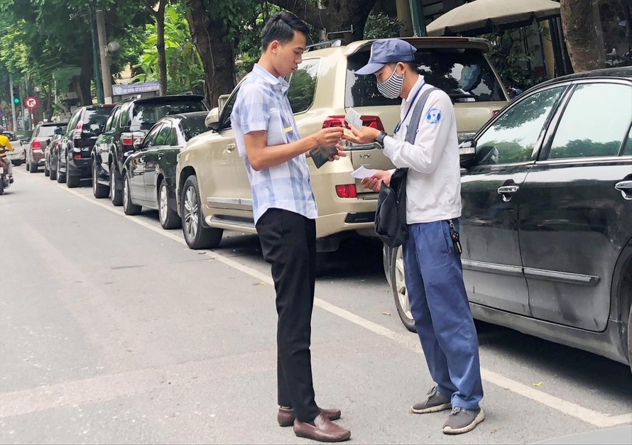 Sáng 8/9 nhân viên tại tất cả các điểm trông xe iParking trên phố Trần Hưng Ðạo đều thu tiền mặt của khách
