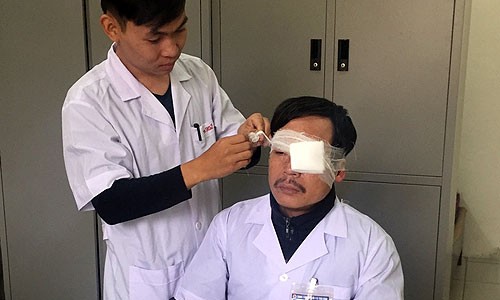 Bác sĩ Nghĩa được đồng nghiệp băng bó tạm vết thương. 